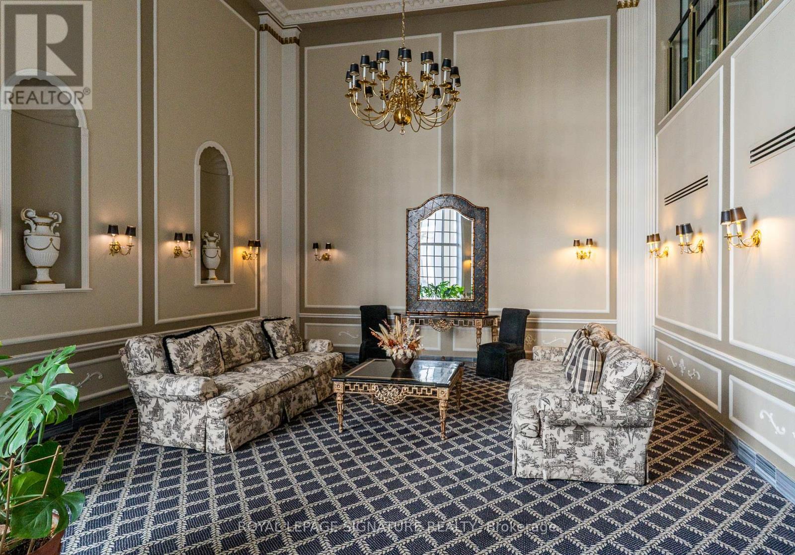 Elegant building lobby with chandelier and classical decor