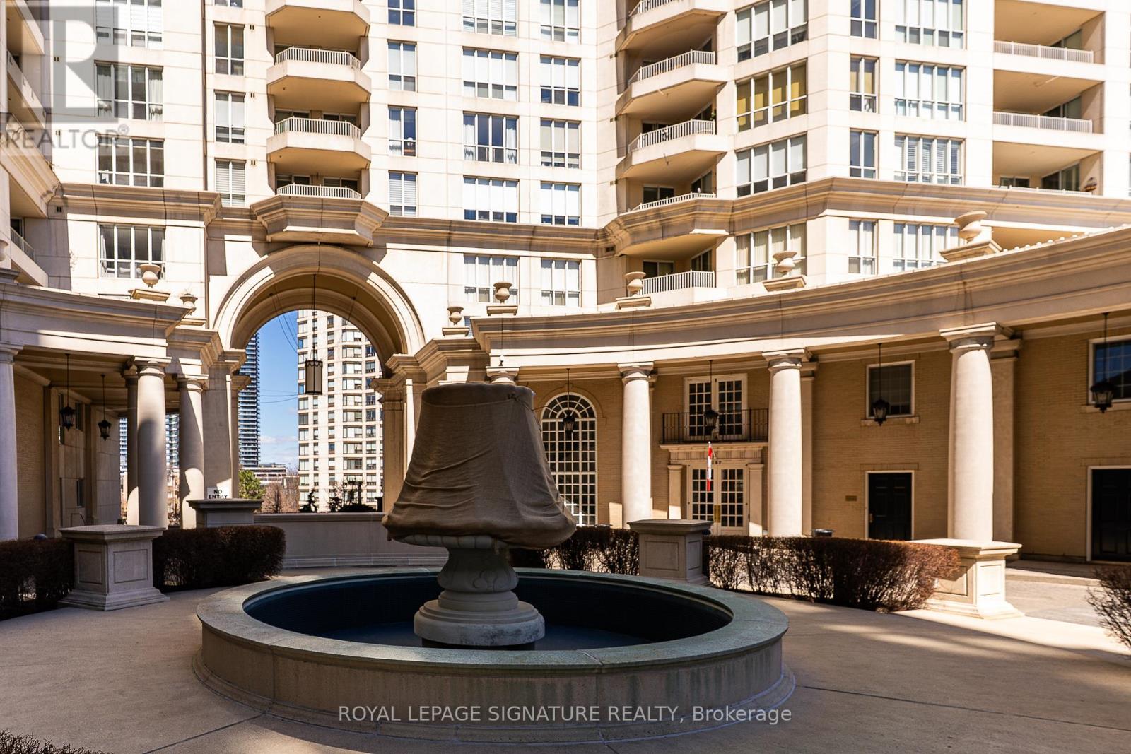Building courtyard with fountain and stone colonnade