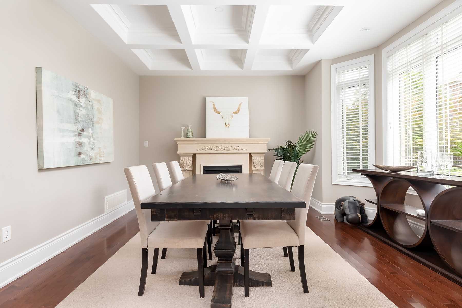 Dining room of 33 Noce Way with a coffered ceiling, fireplace, and bay windows