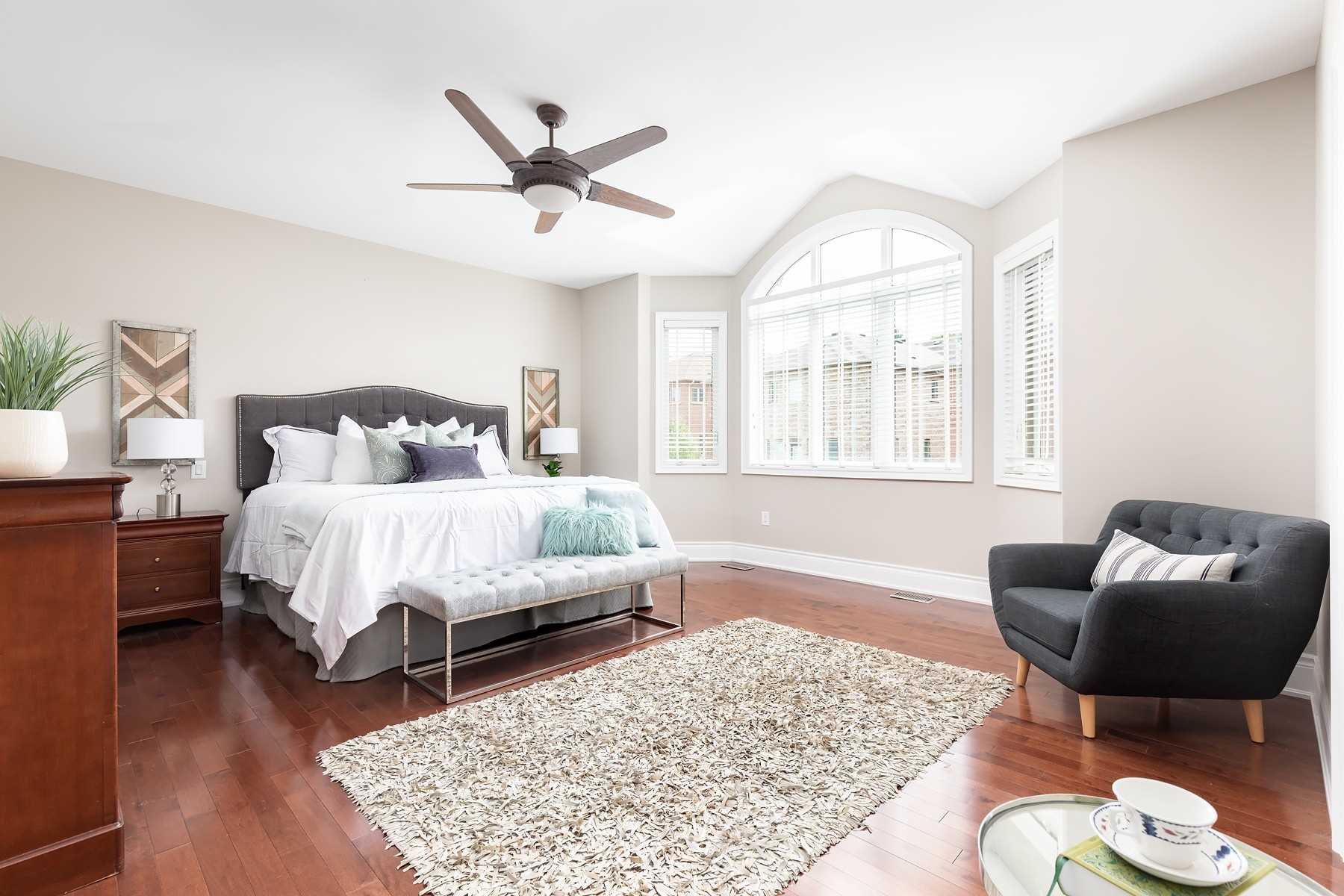 Primary bedroom of 33 Noce Way with a king bed, bay window, and hardwood floors