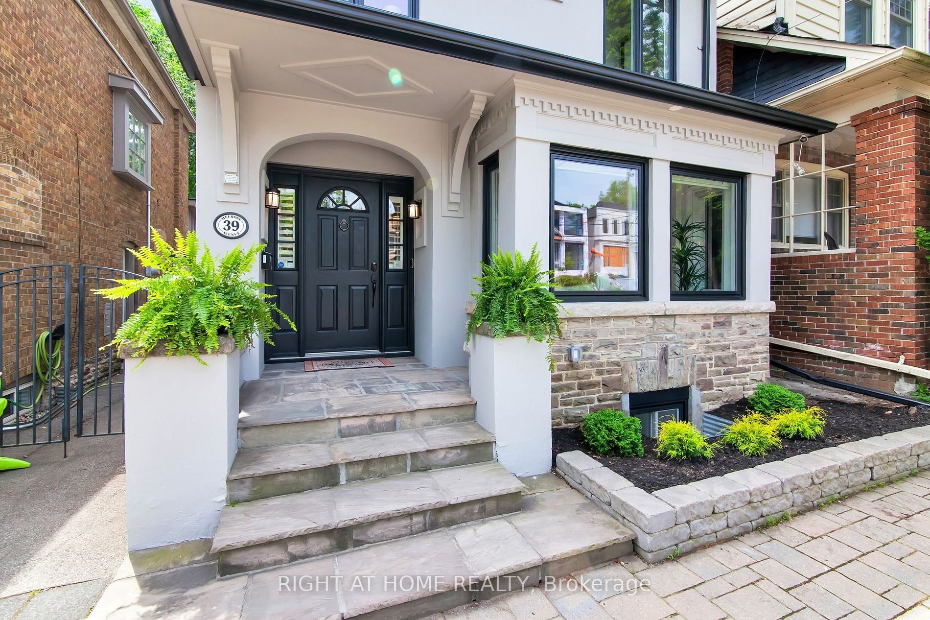 The front entrance at 39 Melrose — 39 plaque, black front door and ferns