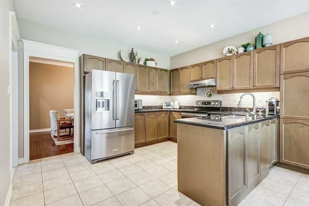 Bright kitchen with stainless steel appliances, wood cabinetry, and island at 81 Alamo Heights Drive
