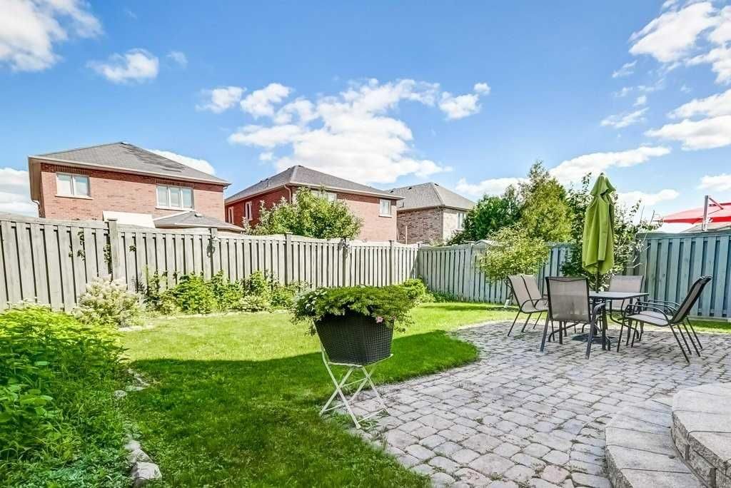 Fully fenced backyard with interlock patio and patio furniture at 81 Alamo Heights Drive